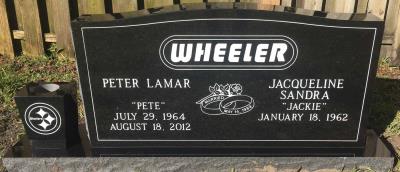 black granite companion upright headstone with the Pittsburgh Steelers logo and custom font surname